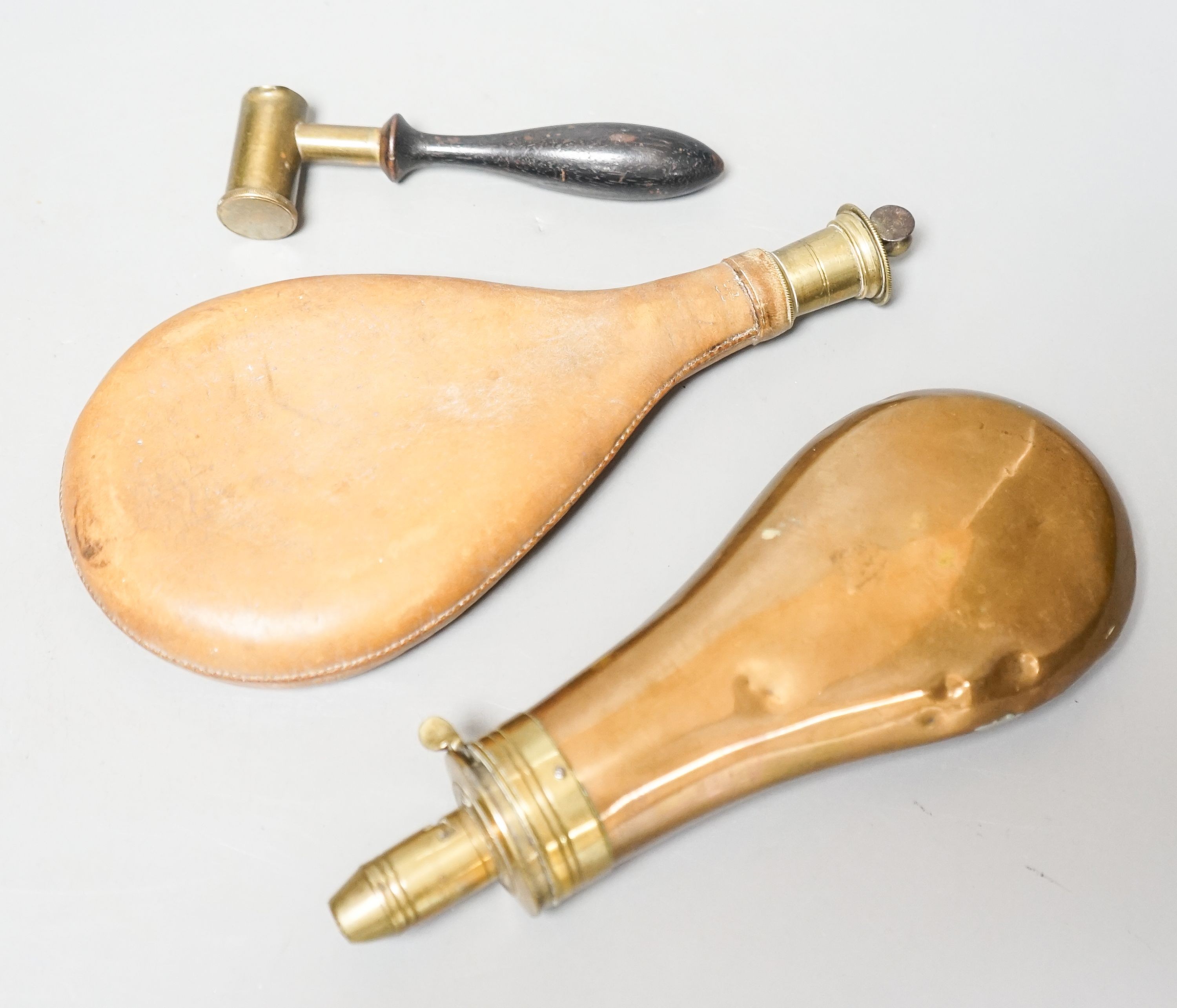 Two 19th century shot flasks and a powder measure